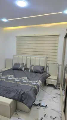 a bedroom with a large bed with black sheets at اربد لواء الوسطية كفرعان مجسم البتراء