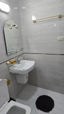 a bathroom with a sink and a toilet and a mirror at اربد لواء الوسطية كفرعان مجسم البتراء