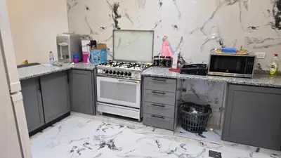 a kitchen with marble counter tops and a stove at اربد لواء الوسطية كفرعان مجسم البتراء