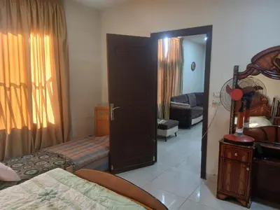 a room with a bedroom with a bed and a mirror at Hana Home in Amman