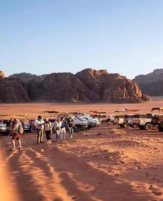 a group of people walking in the desert at Hillawi Desert Camp Wadi Rum in Disah