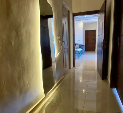 a hallway with a door and a room with chairs at شقه للإيجار عجلون -رأس منيف in Ajloun