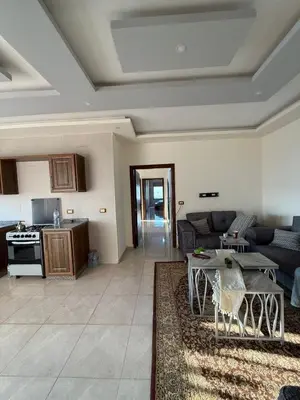 a living room with a couch and a table at شقه للإيجار عجلون -رأس منيف in Ajloun