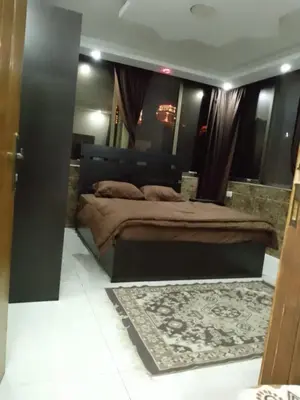a bedroom with a large bed and a rug at شقق تلاع العلي in Amman