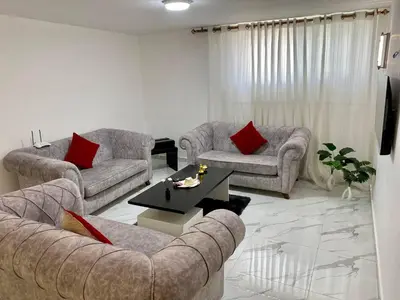 a living room with two couches and a coffee table at W3 property in Kerak