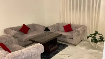 a living room with two couches and a coffee table at W3 property in Kerak