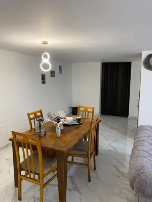 a dining room with a wooden table and chairs at W3 property in Kerak