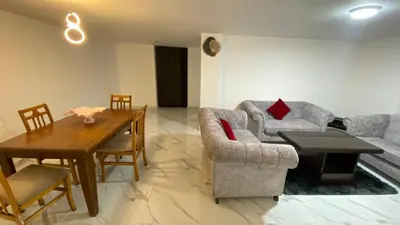 a living room with a couch and a table at W3 property in Kerak