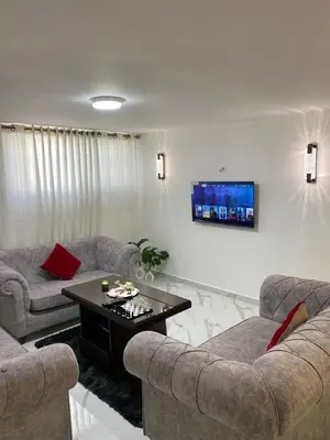 a living room with two couches and a table at W3 property in Kerak