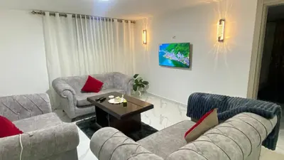 a living room with two couches and a coffee table at W3 property in Kerak