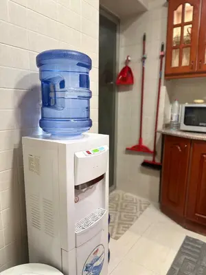 a large blue bucket sitting on top of a refrigerator at Welcome to our prime location flat in Amman