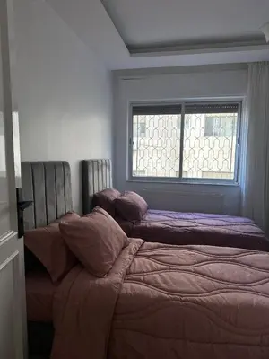a bedroom with two beds and a window at Welcome to our prime location flat in Amman