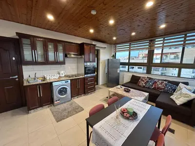 a kitchen and living room with a couch and a table at 7th Circle 1 bedroom flat Amman, pleasant views in Amman