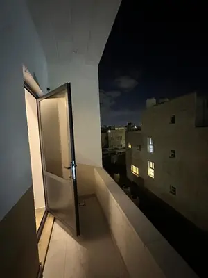 an open door to a balcony of a building at Furnished Apartment in Bushrá