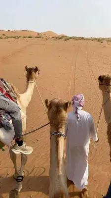 a man riding a camel in the desert at Camel riding trip in Disah