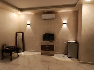 a room with two lights on a wall with a television at غرفه مفروشه ومكيفه بجانب الكارفور اربد in Irbid