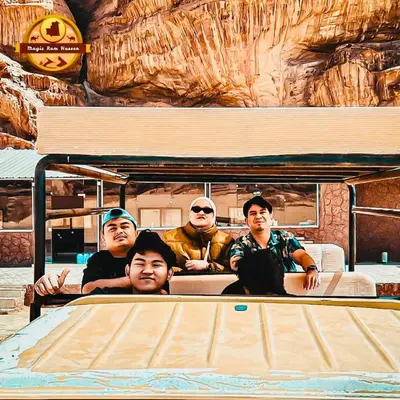 a group of people sitting on a surfboard at Wadi rum magic Luxury in Wadi Rum