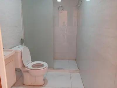 a bathroom with a pink toilet and a shower at Star Gate Camp in Wadi Rum