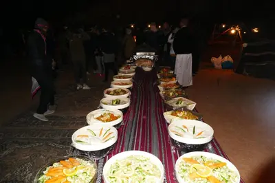 a long line of plates of food on a table at Hillawi Private Bedouin Camp in Wadi Rum
