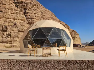 two chairs and a tent in the desert at Echo of the Sands in Wadi Rum