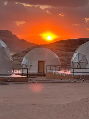 a group of domes in the desert at sunset at Desert Star Camp in Disah