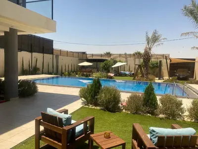 a resort with a swimming pool and a resort at Atlantis The Palm Villa in Al Rama