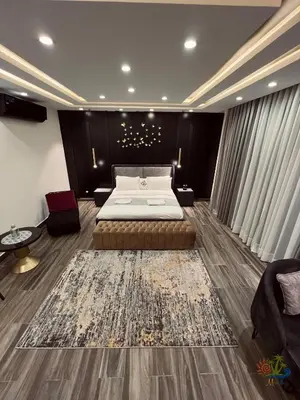 a bedroom with a large bed and a large rug at Mirabella Villa in Al Rama