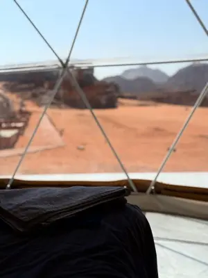 a view of the desert from a window of a tent at Luxury Camp Wadi Rum in Disah