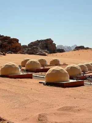 a group of domes sitting in the desert at Luxury Camp Wadi Rum in Disah
