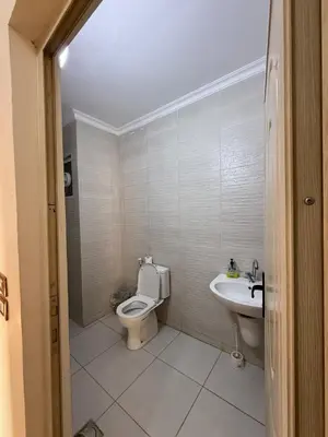 a bathroom with a toilet and a sink at شقة للإيجار في عجلون in Ajloun
