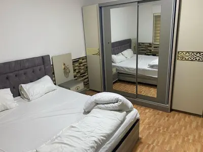 a bedroom with a bed and a large mirror at jawharet el ordon in Amman