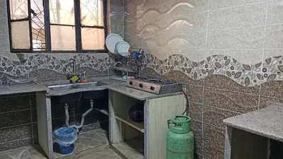 a kitchen with a sink and a stove at عجلون اشتفينا in Ajloun