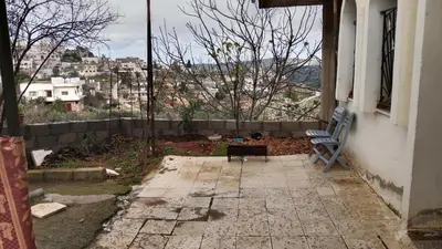 a bench sitting on the side of a building at عجلون اشتفينا in Ajloun
