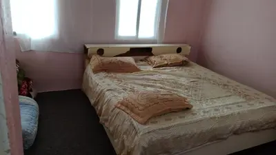 a small bedroom with a bed with a window at عجلون اشتفينا in Ajloun