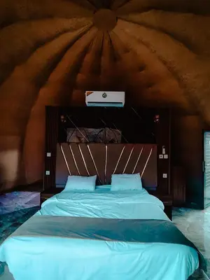 a bedroom with a large bed in a room at Solar Soul Camp - Wadi Rum Desert Experience & Stargazing in Wadi Rum