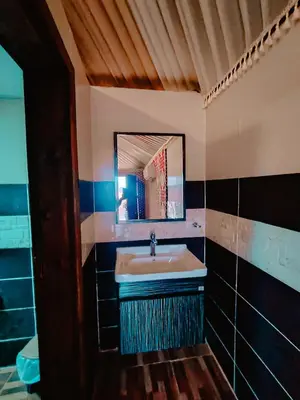 a bathroom with a sink and a mirror at Solar Soul Camp - Wadi Rum Desert Experience & Stargazing in Wadi Rum