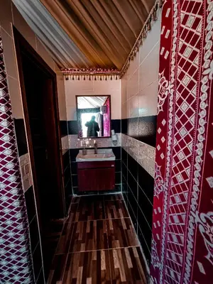 a bathroom with a sink and a mirror at Solar Soul Camp - Wadi Rum Desert Experience & Stargazing in Wadi Rum