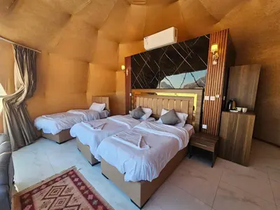 a room with two beds and a mirror at LONAR LORE lUXURY CAMP in Disah