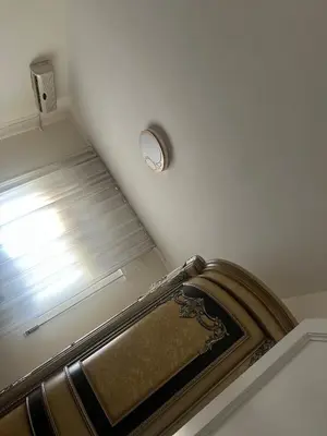 a room with a staircase with a window and a clock at Rasheed pearl in Amman