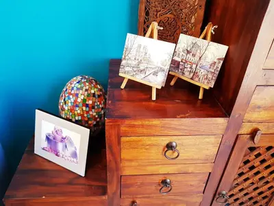 a wooden dresser with two pictures on top of it at Luxury 3 bedrooms flat with great view of Amman in Amman