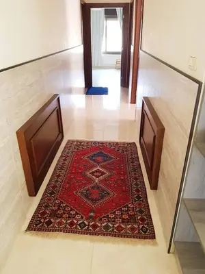 a hallway with a red rug on a floor with a door at Luxury 3 bedrooms flat with great view of Amman in Amman