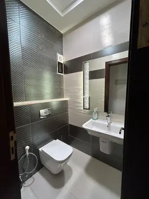 a bathroom with a toilet and a sink at 3BR Escape with Outdoor Scenic Views in Amman