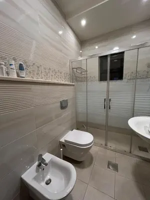 a bathroom with a toilet and a sink at 3BR Escape with Outdoor Scenic Views in Amman