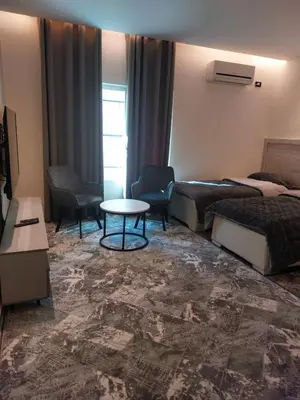 a hotel room with two beds and a table at رياحين الخلود in Amman