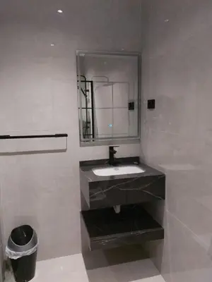 a bathroom with a sink and a mirror at رياحين الخلود in Amman