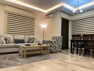 a living room with a couch and a table at 3 bedroom flat, 3 bathrooms, 7th circle, Amman in Amman