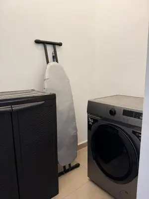 a washing machine with a pillow next to a stove at 2bedrooms sport city in Amman