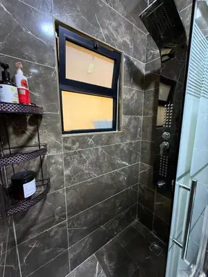 a bathroom with a shower with a window at 2bedrooms sport city in Amman