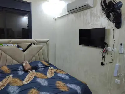 a bedroom with a bed with a teddy bear on it at شقق مفروشه فاخره2 in Aqaba