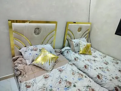 two beds sitting next to each other in a room at شقق مفروشه فاخره2 in Aqaba